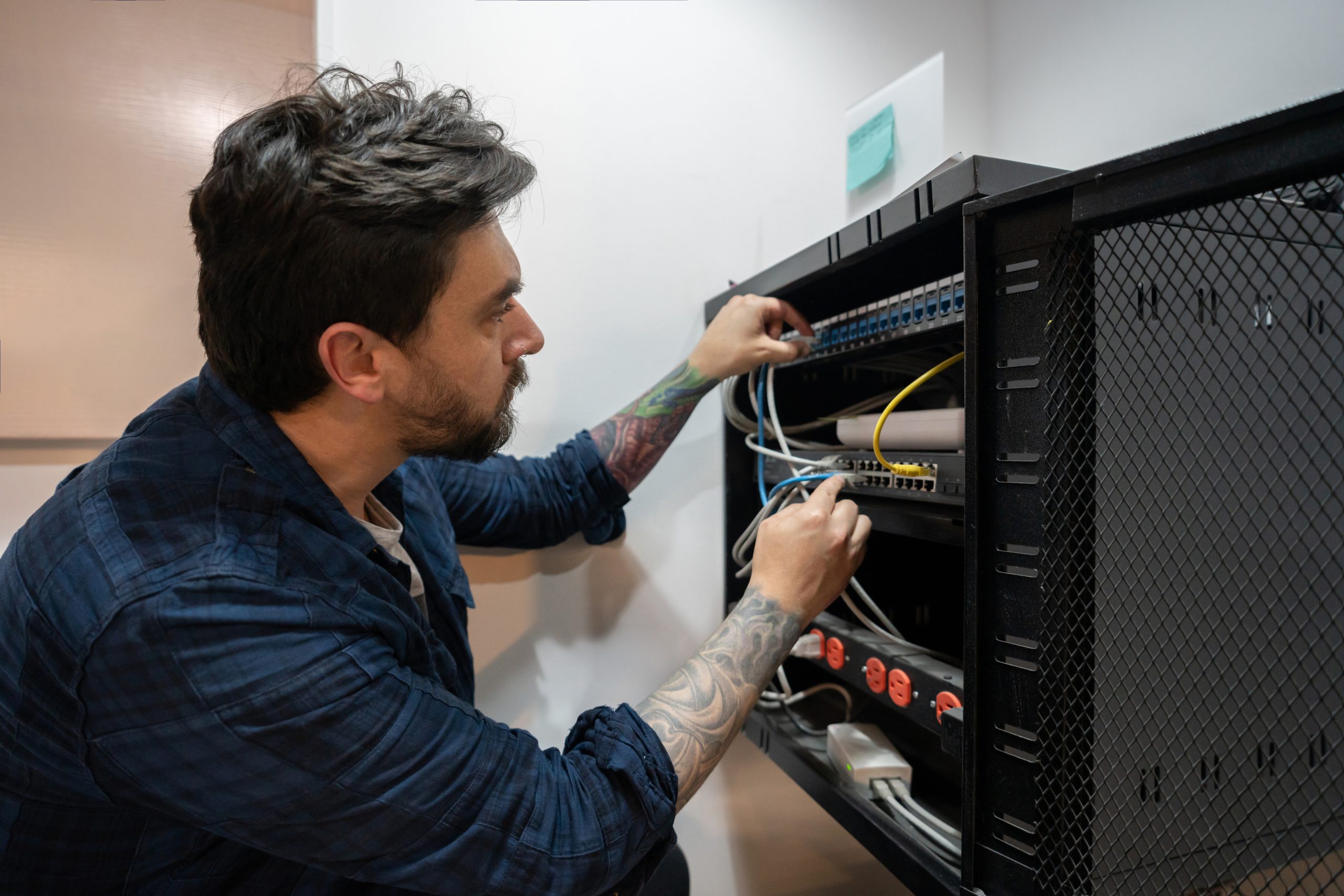 IT support technician connecting a Wi-Fi network in an office environment.